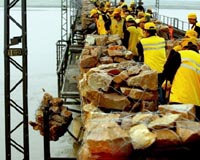 Flood waters threaten millions in China, quake refugees evacuated