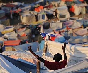 On Haiti hillside mourners pray over mass graves