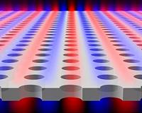Blasting tiny craters in glass, creating material to miniaturize telecommunication devices