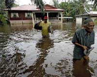 Rescuers struggle to reach flood victims in Malaysia as anger mounts