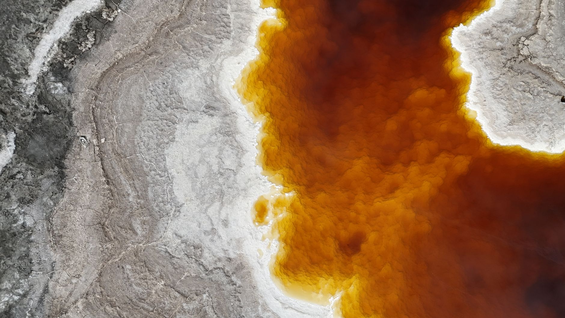 On Titan, Saturn's largest moon, water is the bedrock — frozen to minus 179 degrees and harder than granite — and the rain, rivers and seas that run over it are not water at all but liquid methane, exactly as it comes out of a gas pipe
